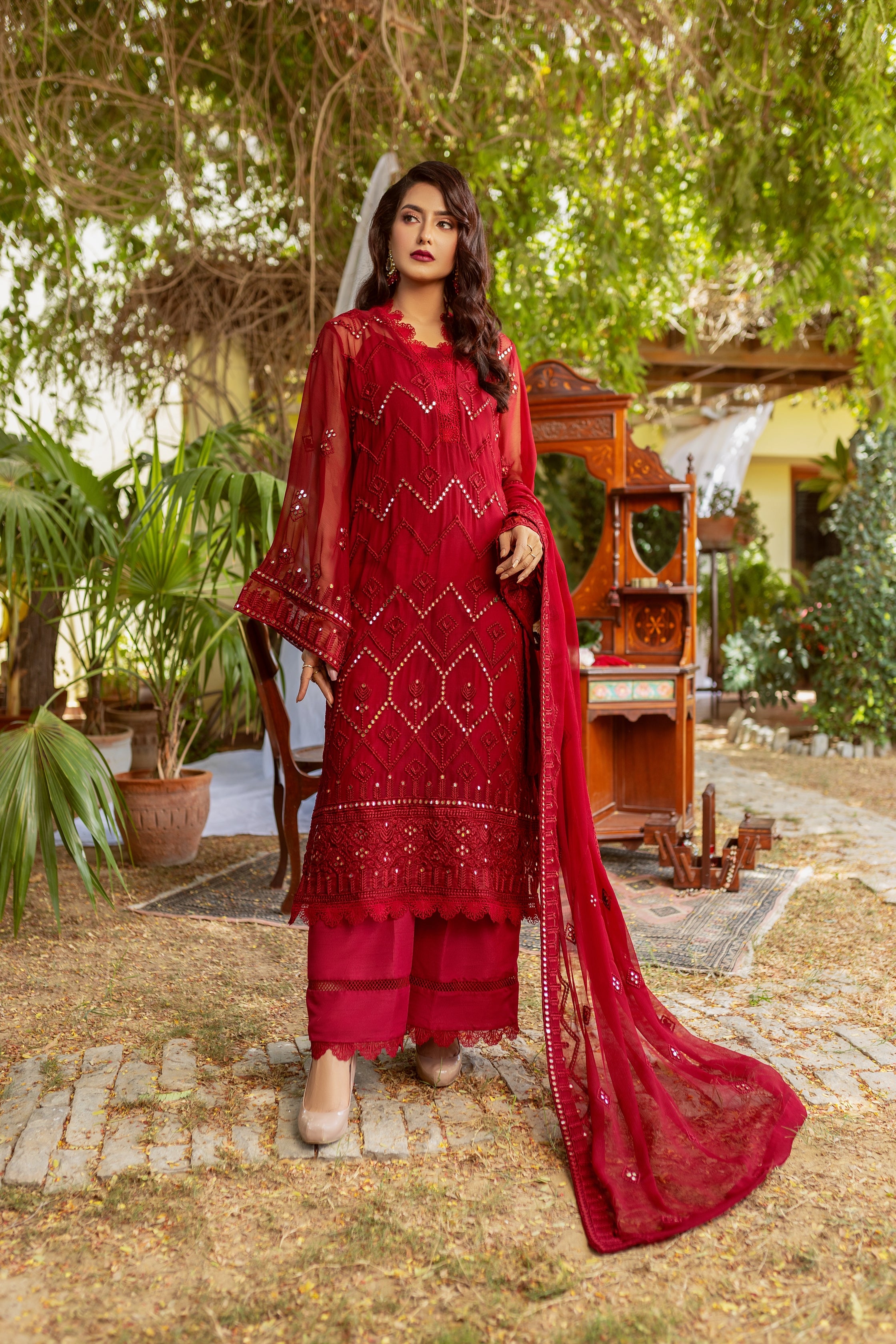 Female model in Red embroided chiffon suit.